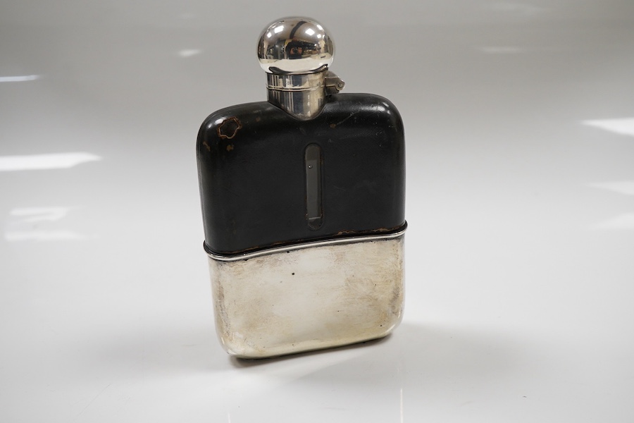 An Edwardian silver and leather mounted glass hip flask, by G & J W Hawksley, Sheffield, 1905/1906, 14.3cm, with engraved initials.